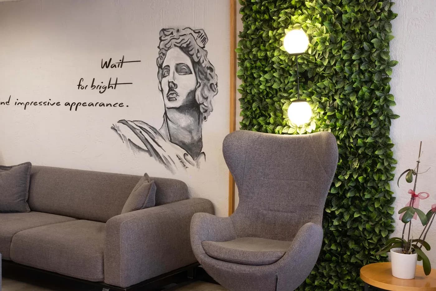 Lounge area with a mural of an Apollo bust