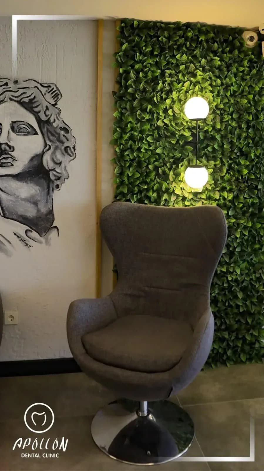 Grey armchair in front of the Apollo mural