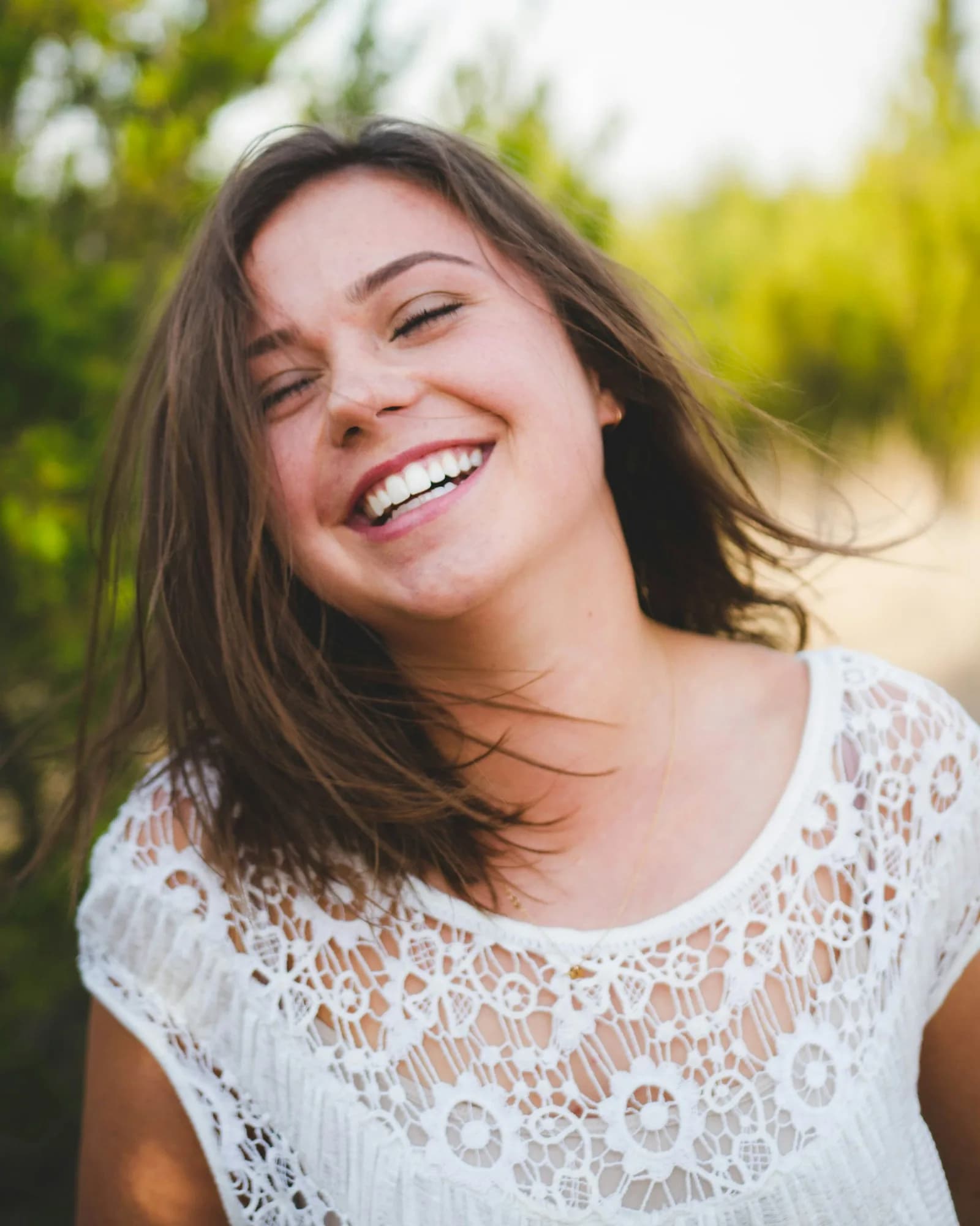 Smiling young woman with natural white teeth
