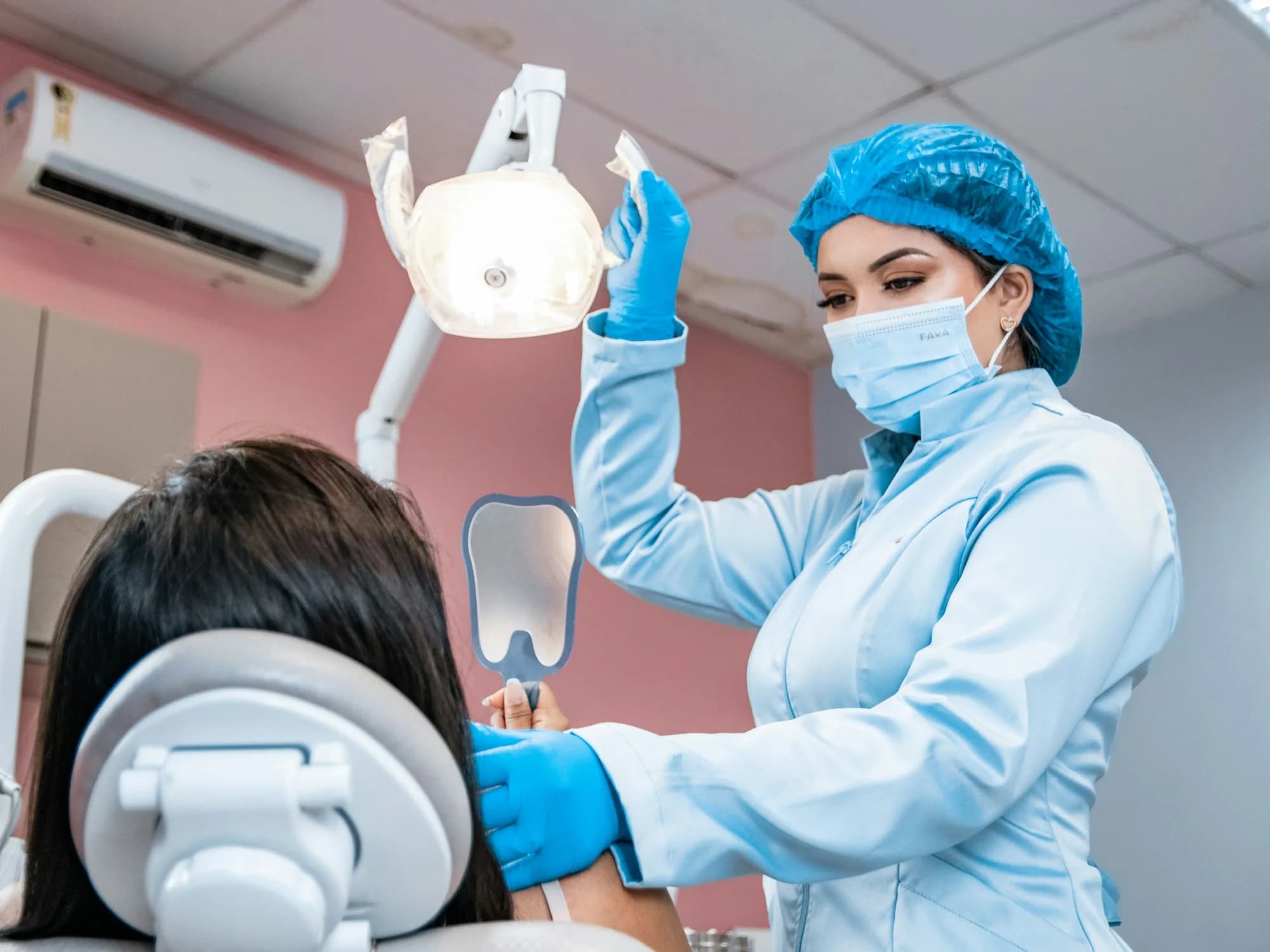Dentist standing beside a patient in the treatment chair